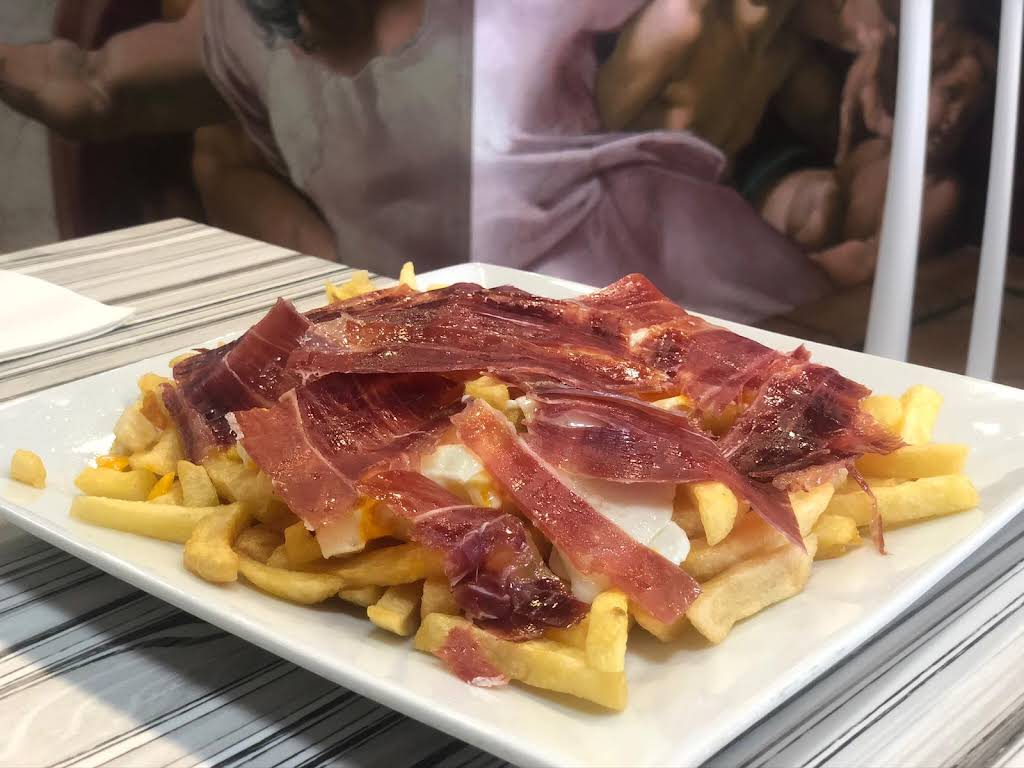 Huevos Rotos — broken eggs over Iberian ham